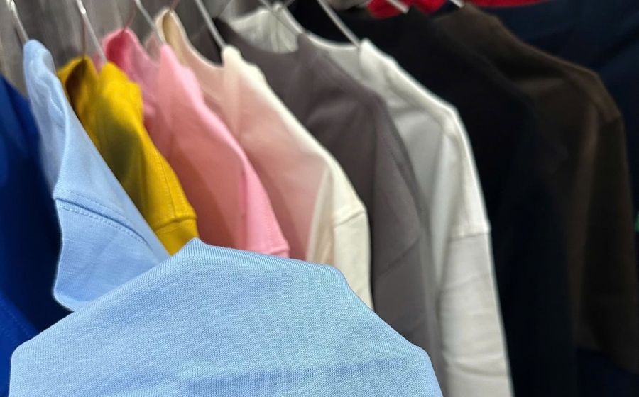 A rack of blank tees in many colors