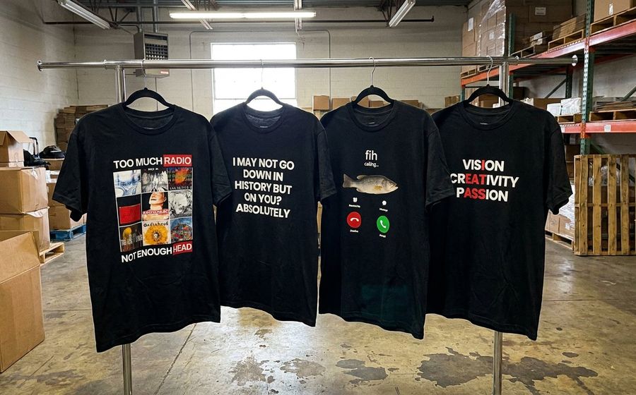 Printed graphic tees hanging in a fulfillment warehouse